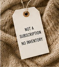 A paper tag resting on a warm woven textile