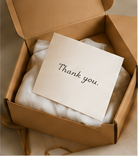A carefully wrapped garment in an open delivery box